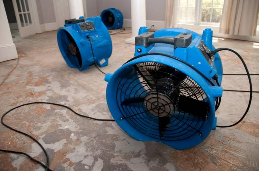 Air movers drying a hard floor after professional cleaning